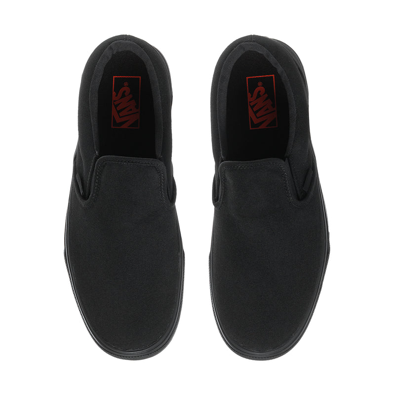 Black slip-on sneakers with inner red logo patch and smooth fabric uppers