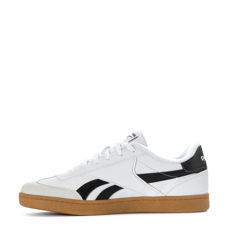 White youth lace-up sneakers with black panels and gum outsole, Reebok logo on side