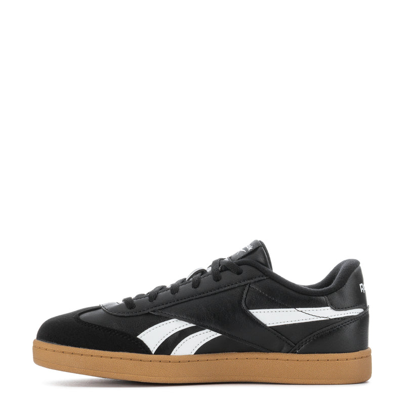 Youth sneakers side view, black upper with white stripes and gum outsole