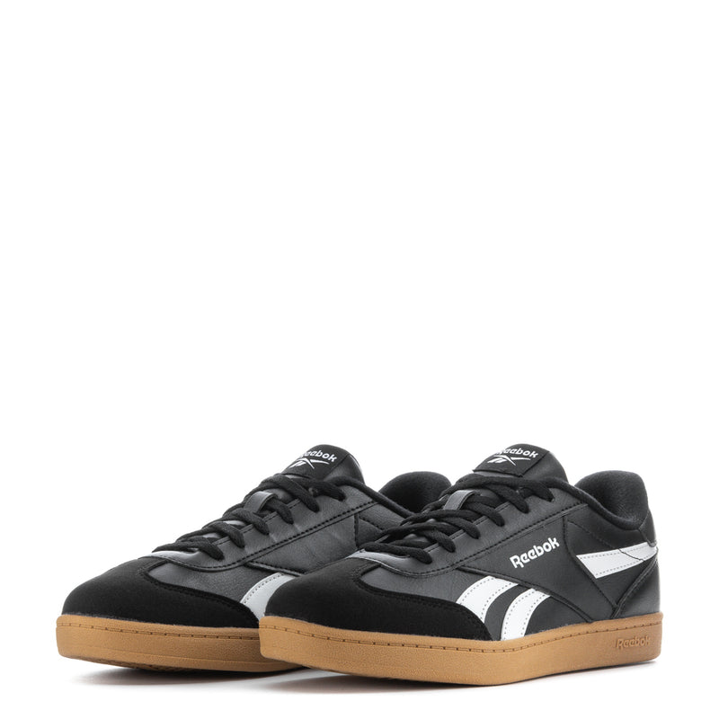 Youth sneakers pair, black upper with white mid-stripe and gum rubber sole
