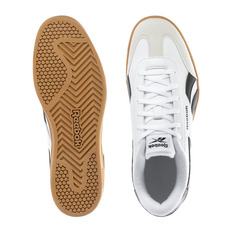 White youth sneakers showing gum outsole tread and lace-up upper with black accents