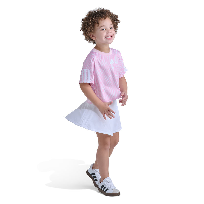 Kids pink striped jersey top with white skort, worn with athletic shoes