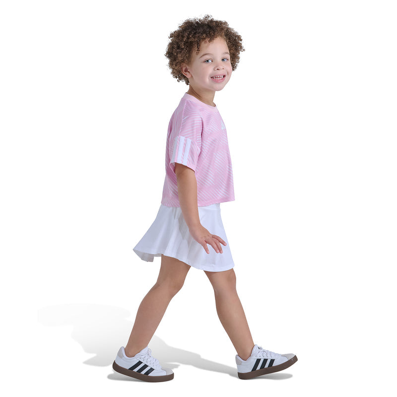 Kids pink striped soccer jersey top with white skort, side view