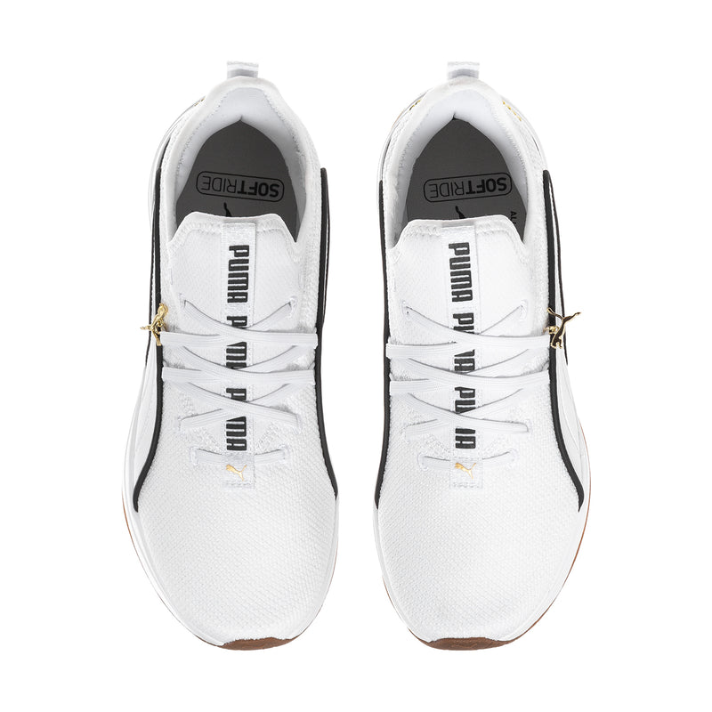Pair of white sneakers showing tongue and inner lining with black PUMA label.