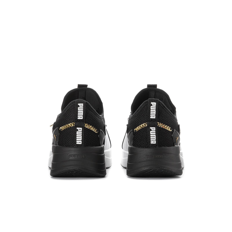 Black sneakers with gold PUMA logo on heel and padded back collar, rear view