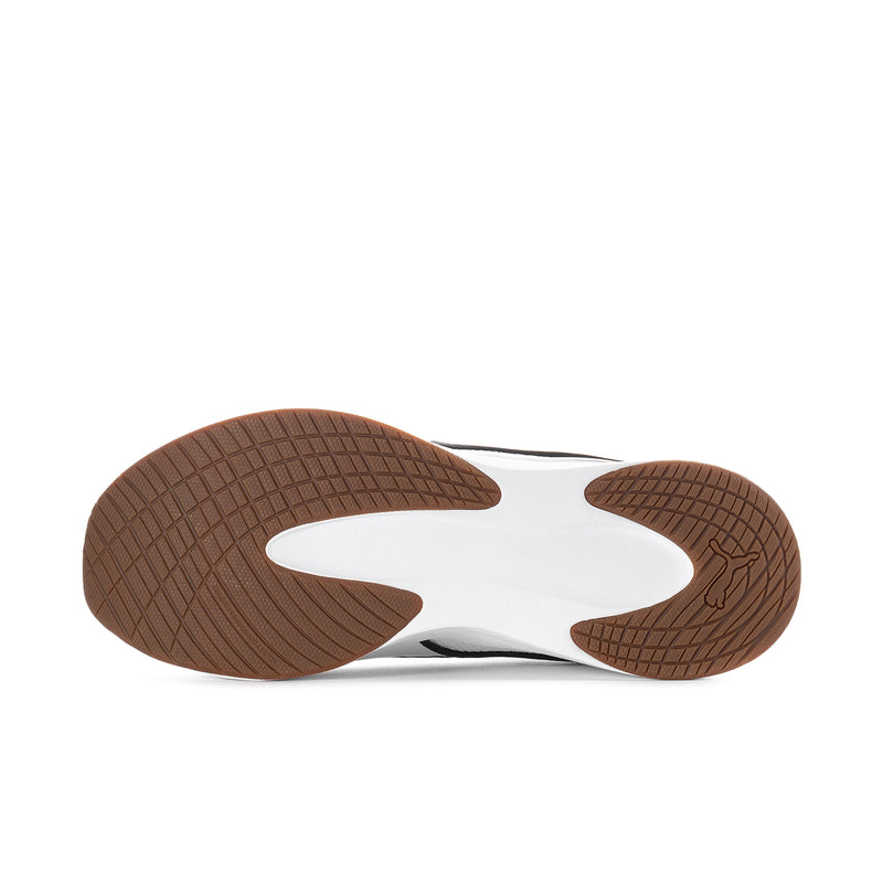 Underside view of white sneaker outsole with brown tread pattern and flex grooves.