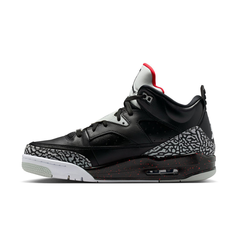 Black low-top sneaker profile with elephant-print toe box trim and red heel collar
