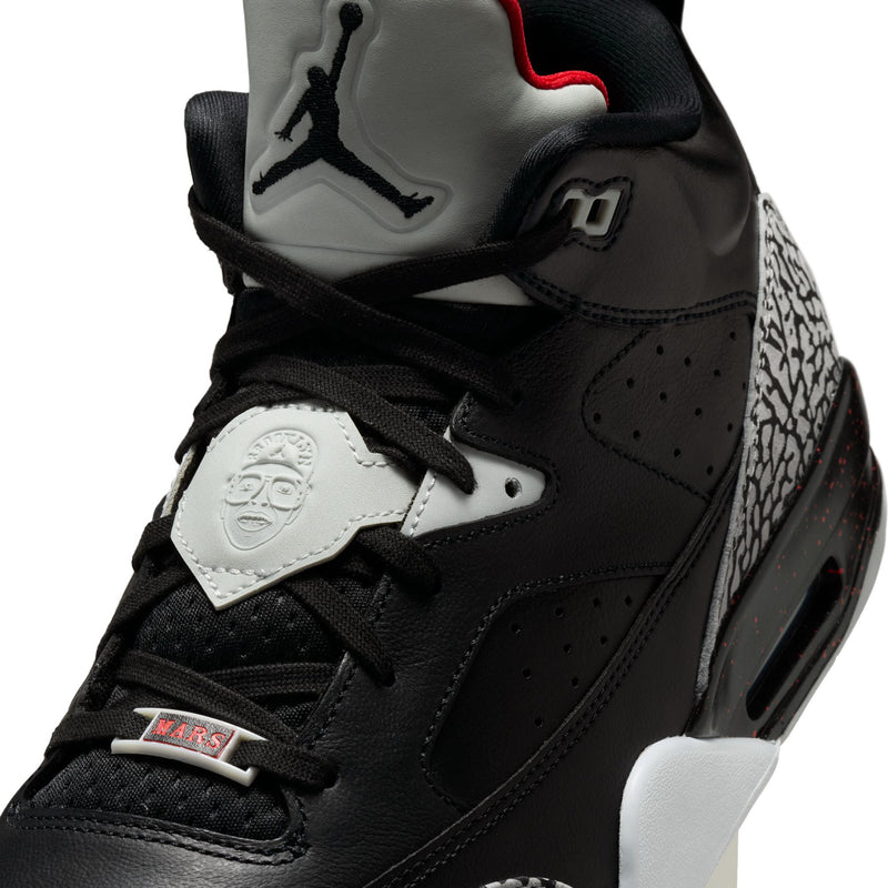 Close-up of black sneaker upper with lace-up front, Jumpman heel logo, and embossed emblem