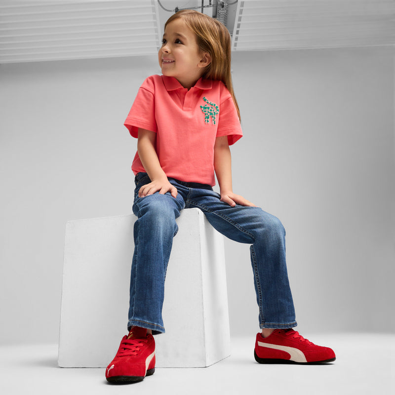 Kids red low-top sneakers with white stripe detail and black sole