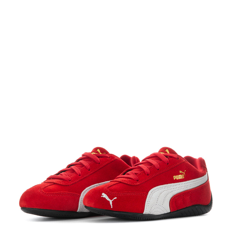 Pair of kids red Puma sneakers with white mid panels and black soles
