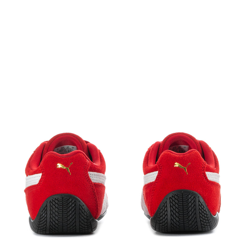 Kids red sneakers heel view with white stripe and black textured sole