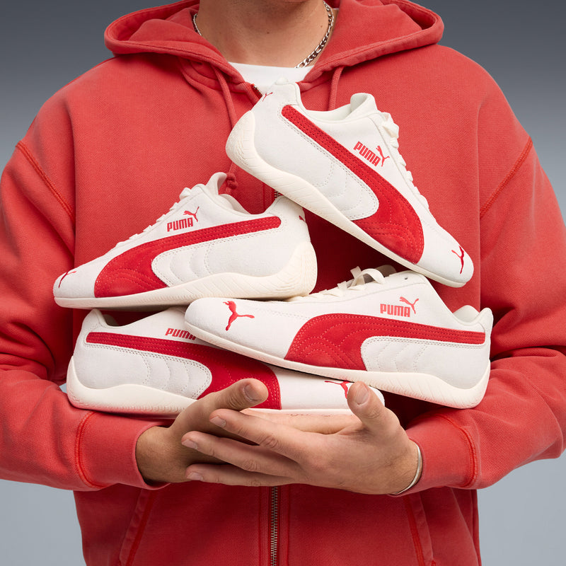 Women's Puma sneaker with off-white upper and red side stripe, laces and toe