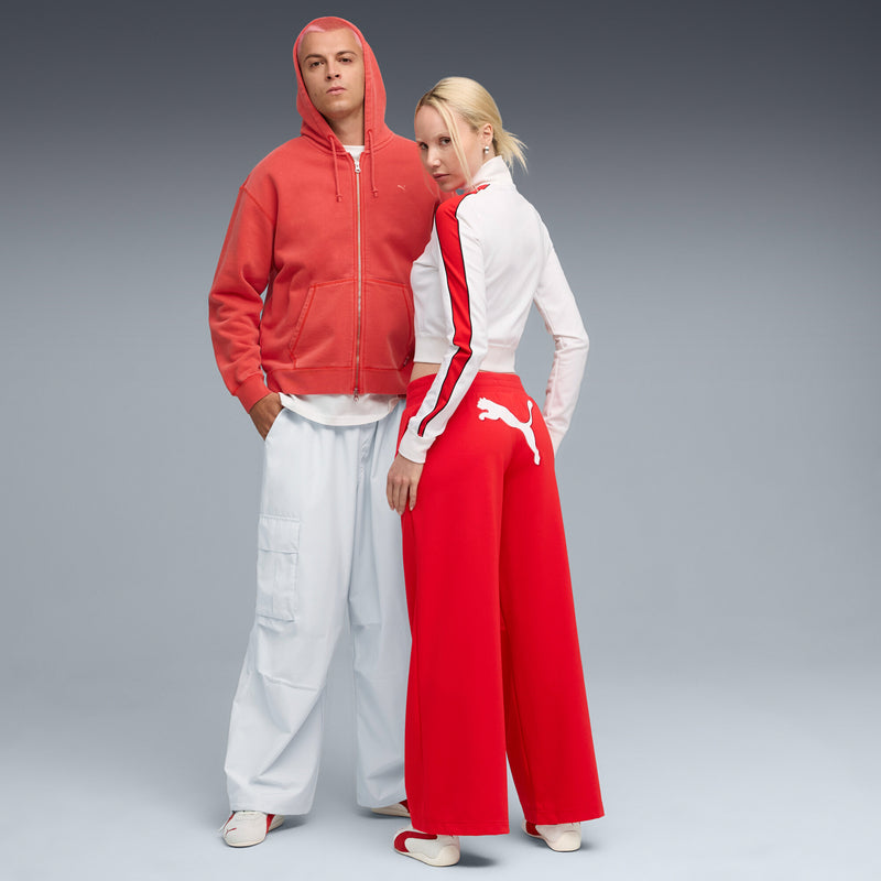 Women's Puma sneakers on model; off-white uppers with red side stripe