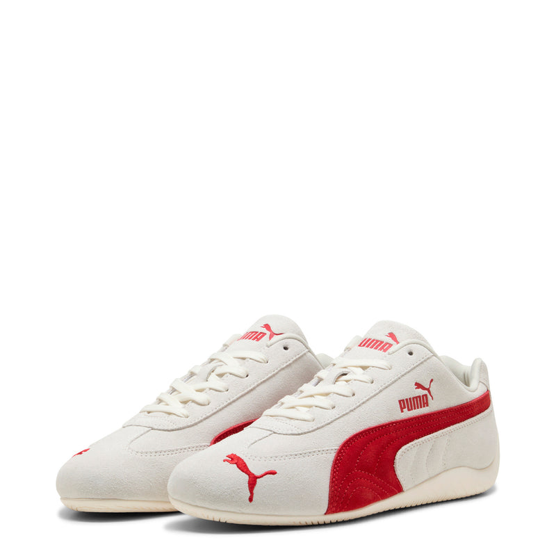 Pair of Women's Puma sneakers; off-white uppers with red side panels and stitched laces