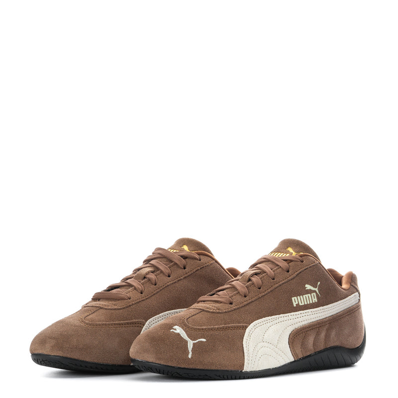 Youth low-top sneakers pair view, brown suede with white Puma logo and black sole.