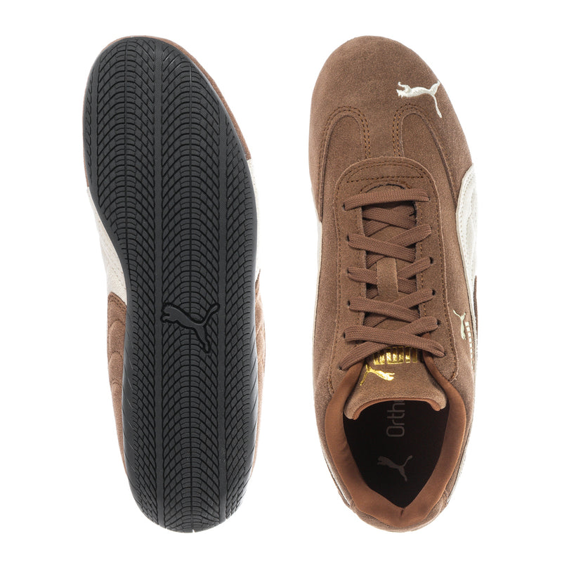 Youth sneakers shown outsole and inner side, brown suede with black tread sole.