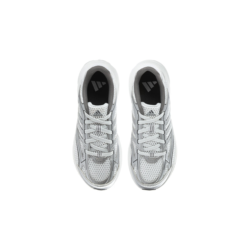 Pair of grey kids sneakers viewed from front, with lace-up vamp and dark lining
