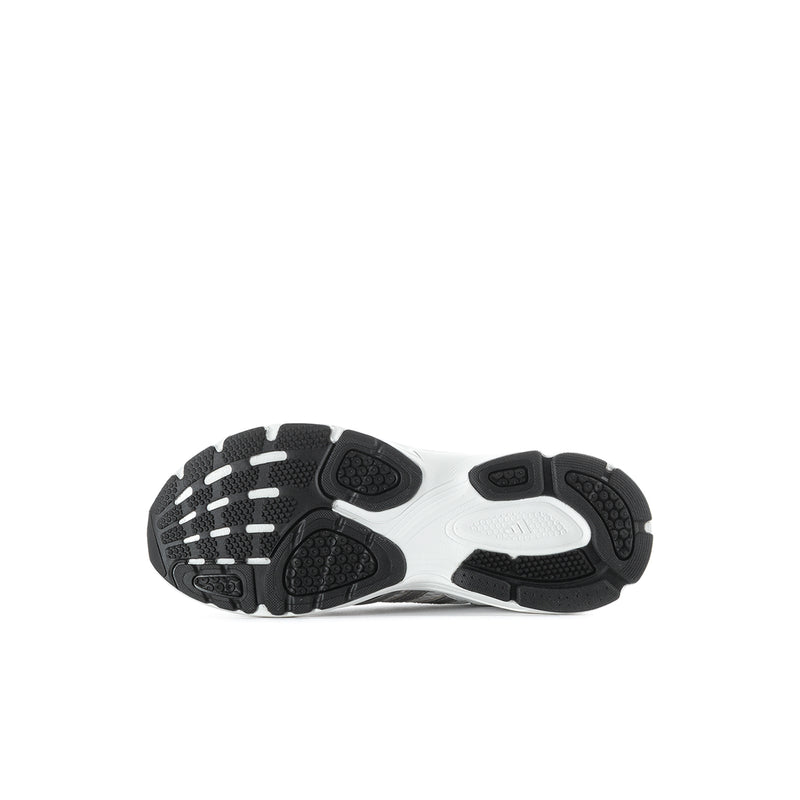 Grey kids sneakers outsole view with textured traction pads and rubber tread