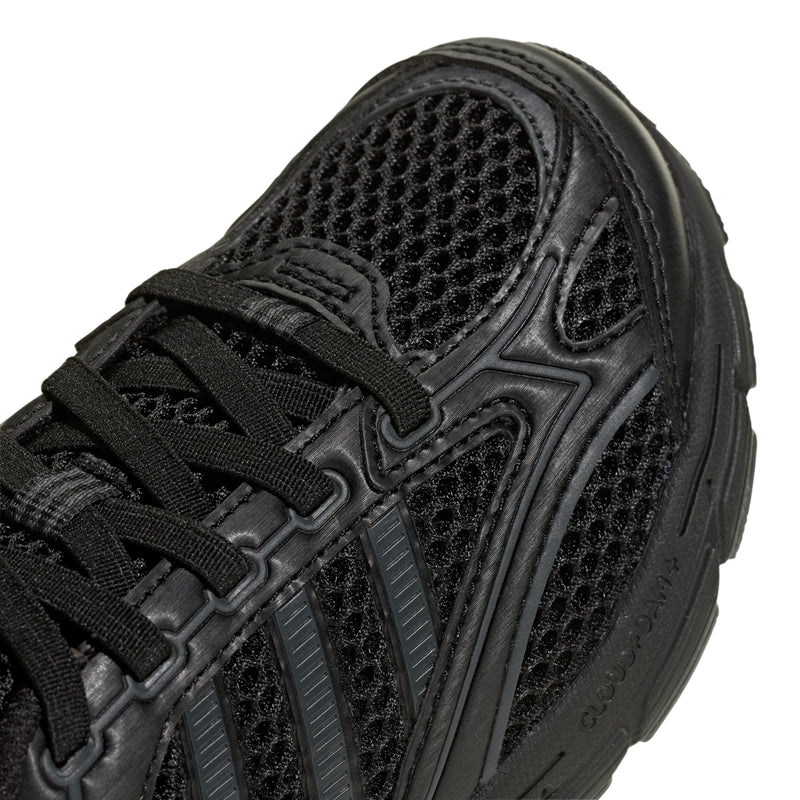 Kids black sneaker close-up of mesh, laces, and side stripes