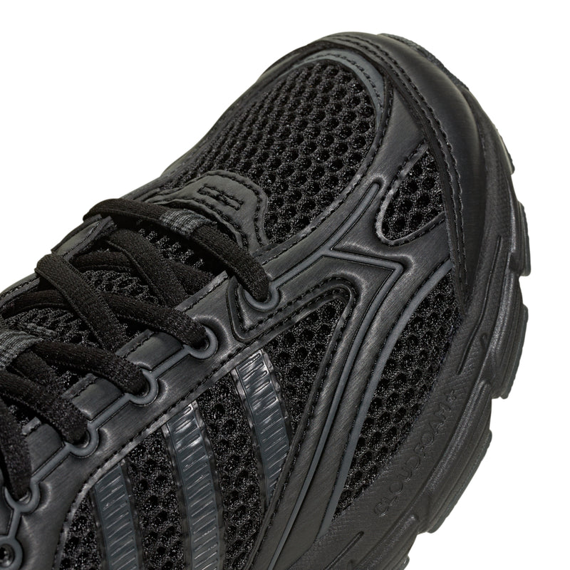 Youth black sneaker upper close-up with mesh panels and lace detail