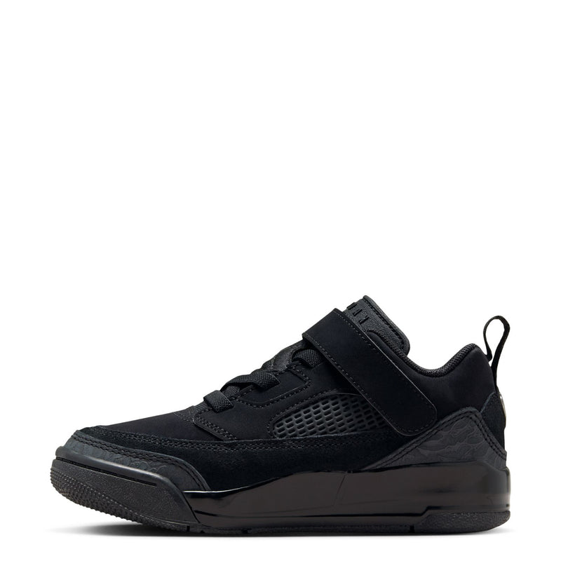 Kids black low-top sneakers, side view with Velcro strap and rubber sole