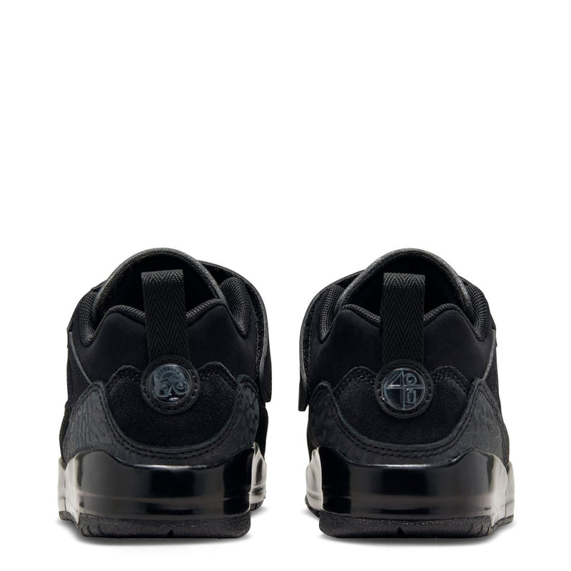 Kids black low-top sneakers with cushioned heel tabs and clear midsole window