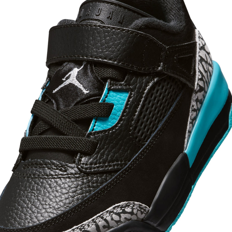 Kids black sneaker upper close-up with turquoise lining, textured overlays, hook-and-loop