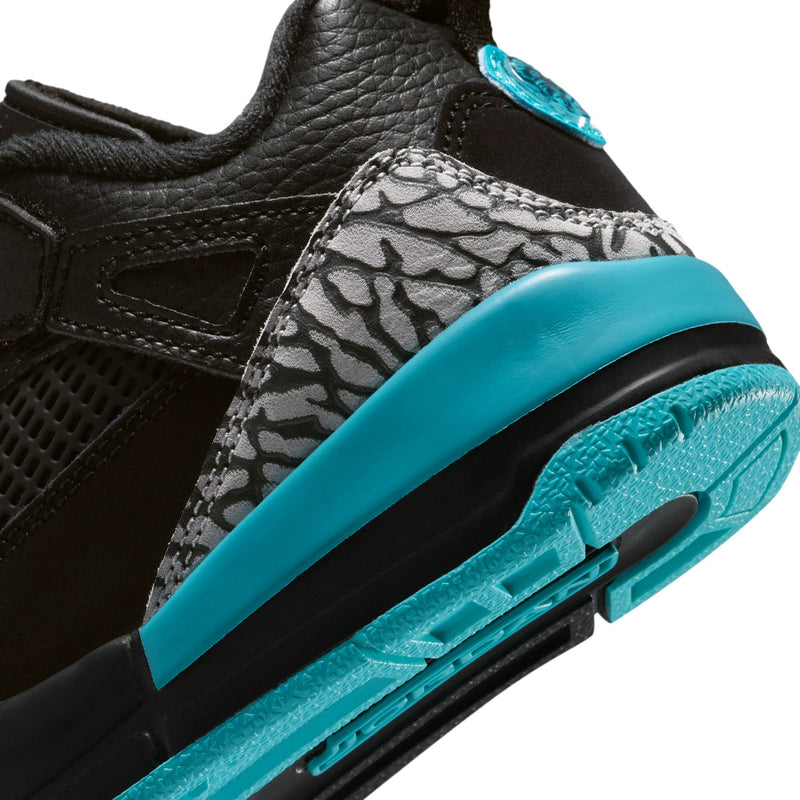 Kids black low-top sneaker close-up with grey snake print, turquoise midsole and laces