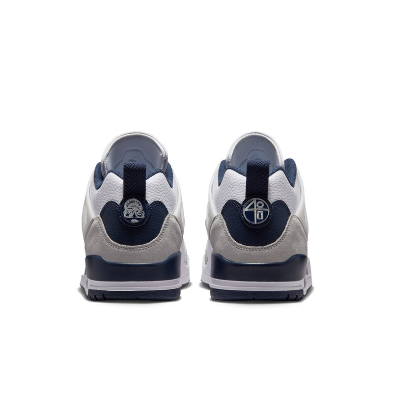 Men's low-top sneakers, rear view with navy heel tabs and cushioned collar
