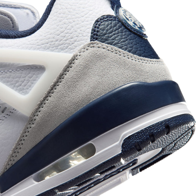 Men's low-top sneakers close-up, navy midsole with visible air cushioning window
