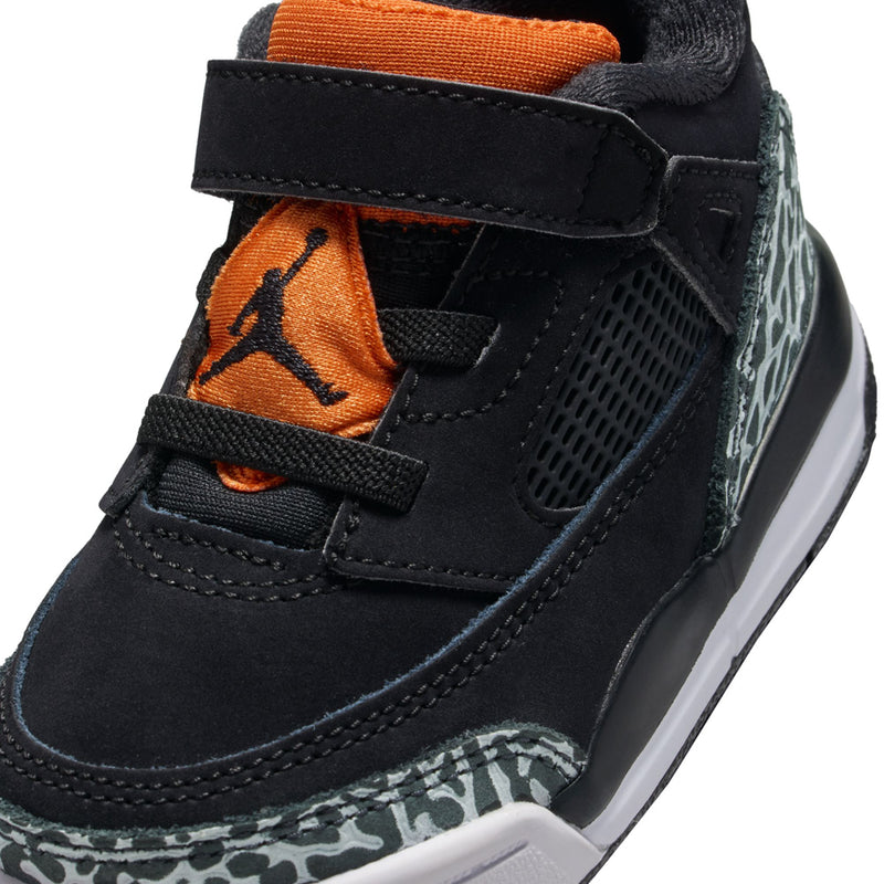Toddler sneaker close-up: black mesh and suede with orange logo and leopard trim