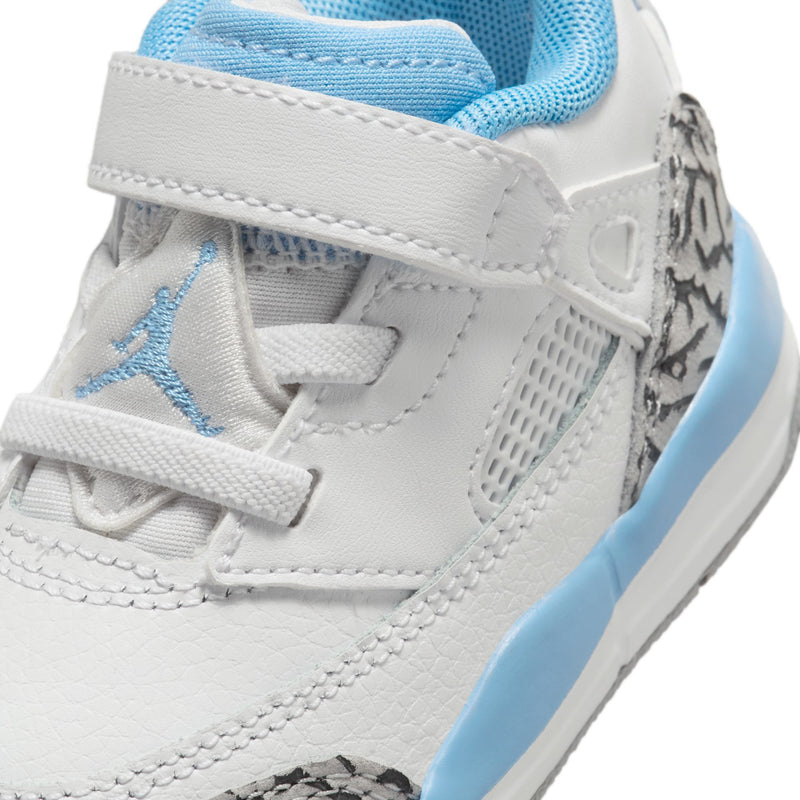 Toddler low-top sneakers close-up; white leather, blue laces, stitched details and leopard trim
