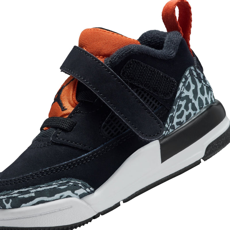 Toddler sneaker close-up: black velcro straps, orange accents, and leopard-print side panel
