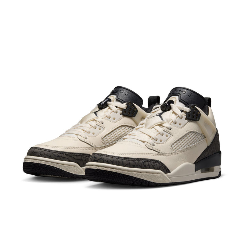 Pair of women’s cream low-top sneakers with black details and lace-up design.