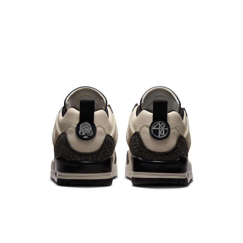 Women’s cream sneakers from the back with black heel tab and padded collar.