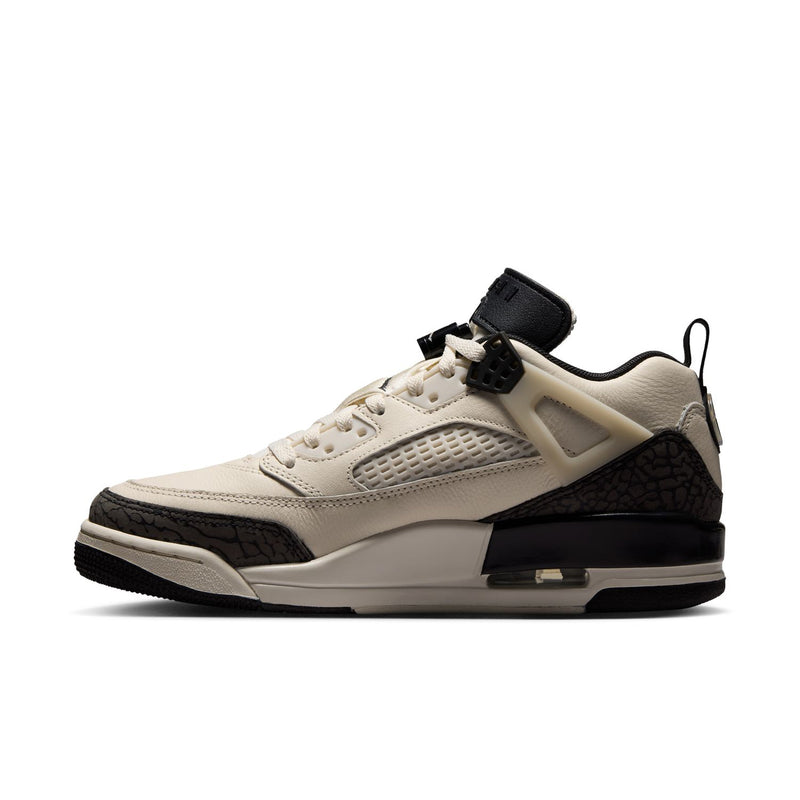 Women’s cream low-top sneaker with black side panel, lace-up closure, cushioned sole.