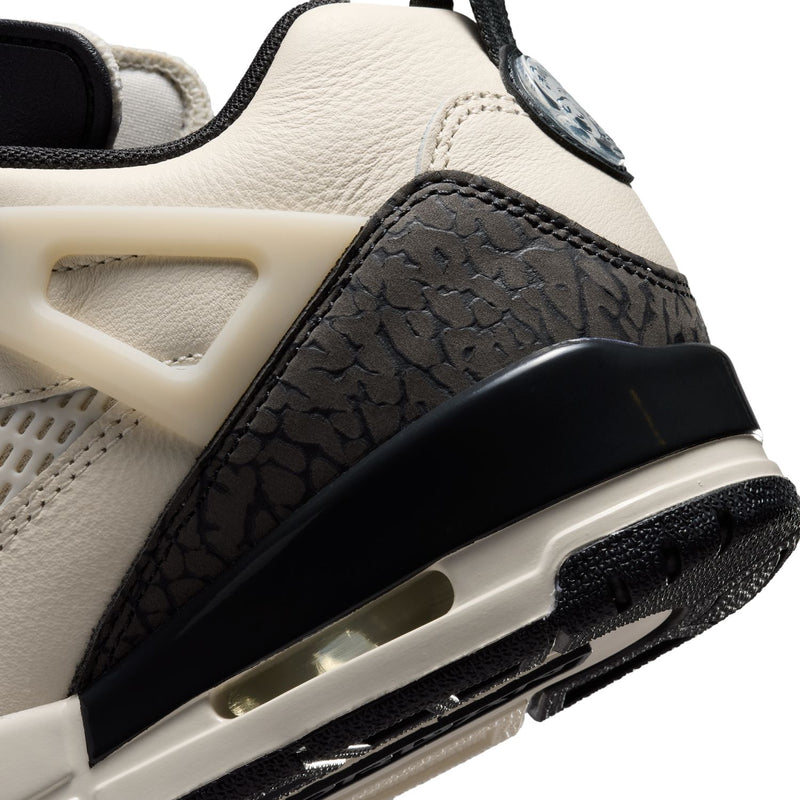Close-up of women’s sneaker midsole with black textured side panel and air-window detail.