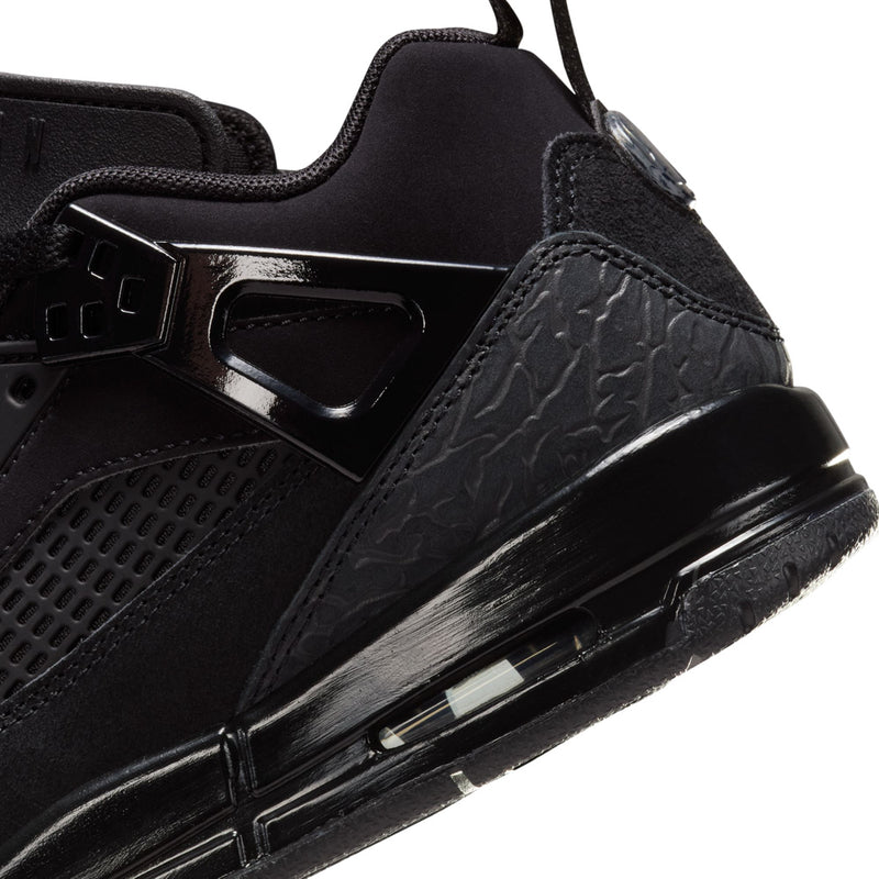 Black youth sneaker side close-up with molded panel, lace stays, and midsole