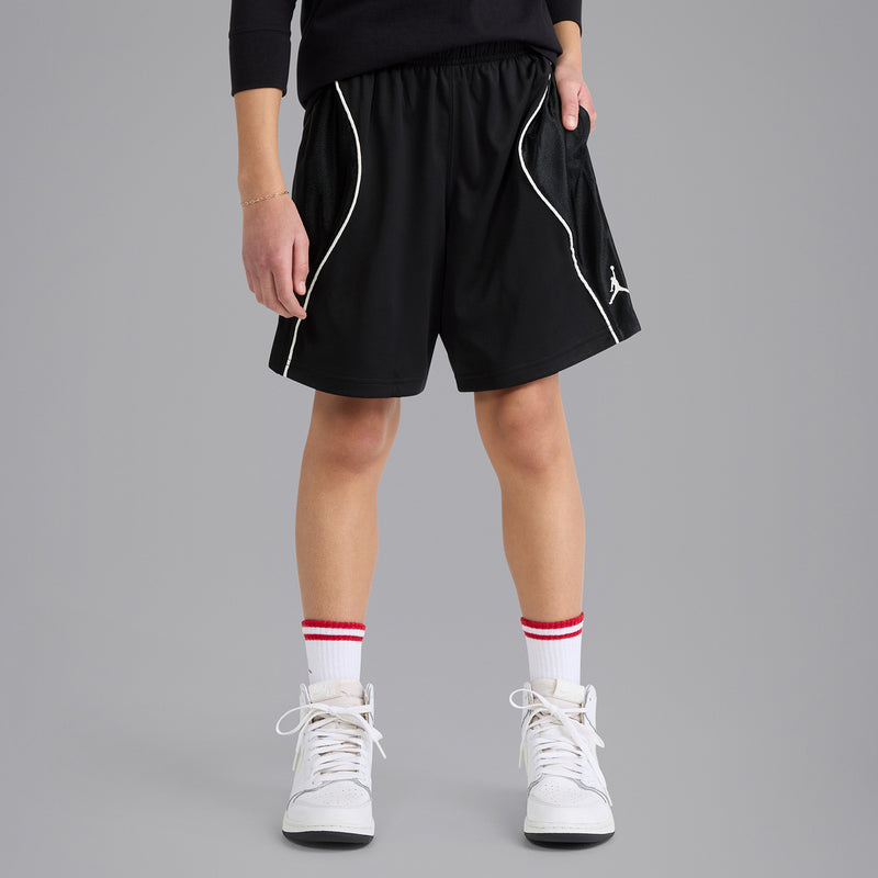 Youth black athletic shorts with white side piping and Jordan logo, elastic waist.