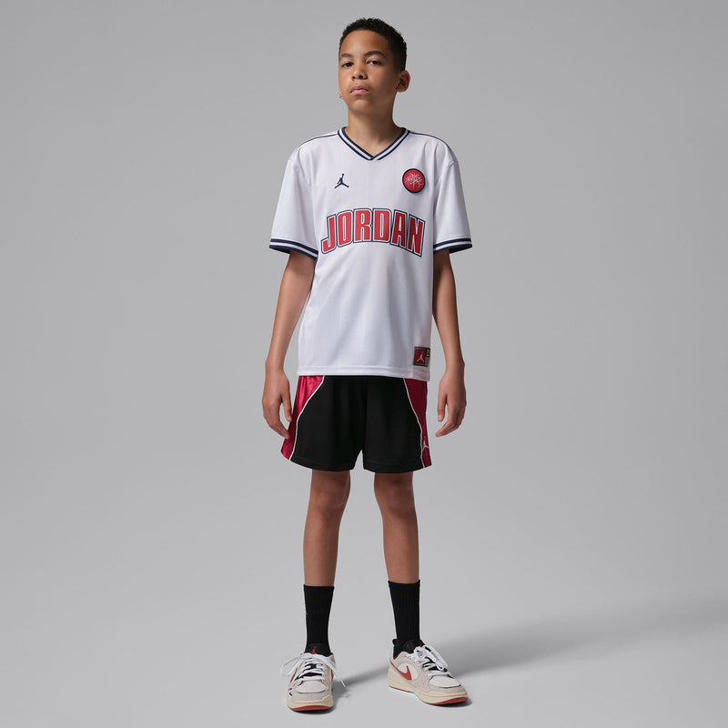 Youth black athletic shorts with gym red side panels, contrast piping, knee-length hem