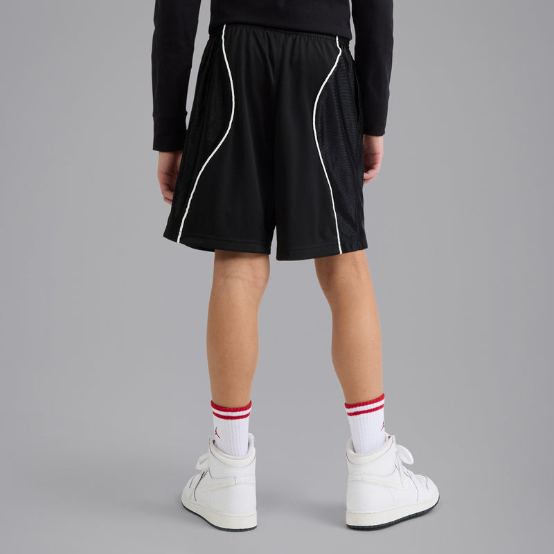 Youth black athletic shorts with white piping along panels, elastic waistband.