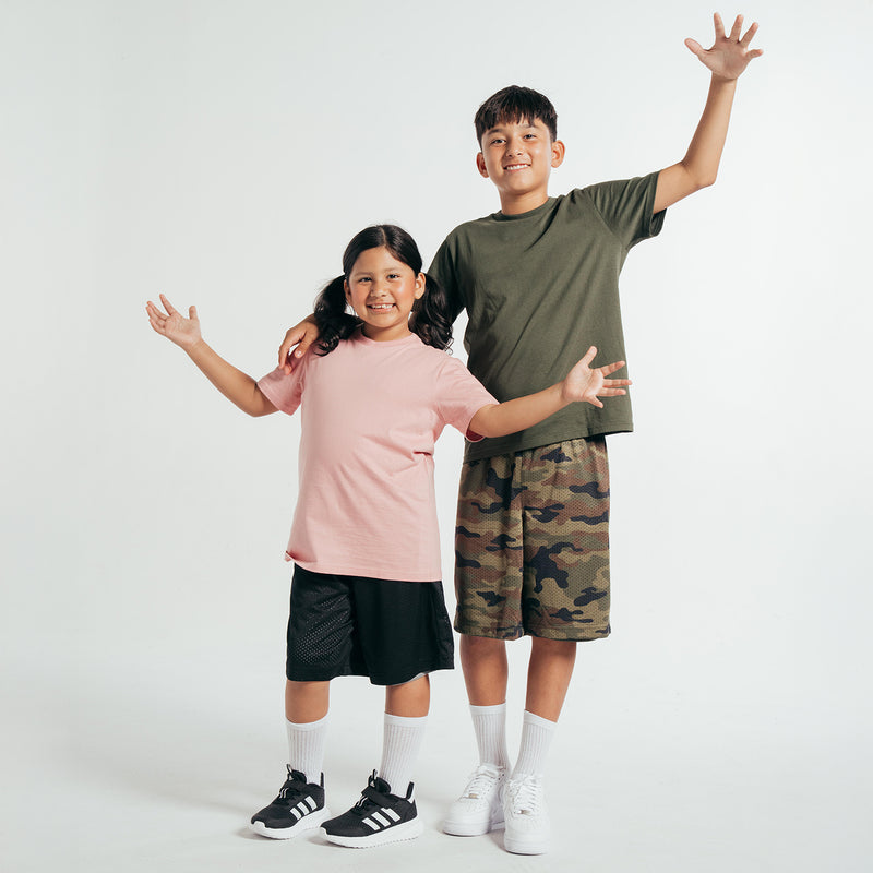 Youth pink crew-neck T-shirt with short sleeves, worn by a child.