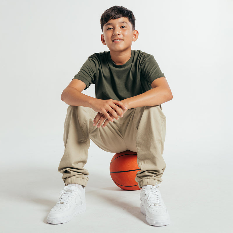 Youth crew T-shirt in dark forest green, boy kneeling, short sleeves crew neck