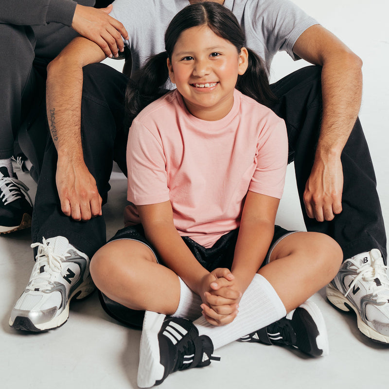 Close-up of a pink crew-neck youth T-shirt with short sleeves.