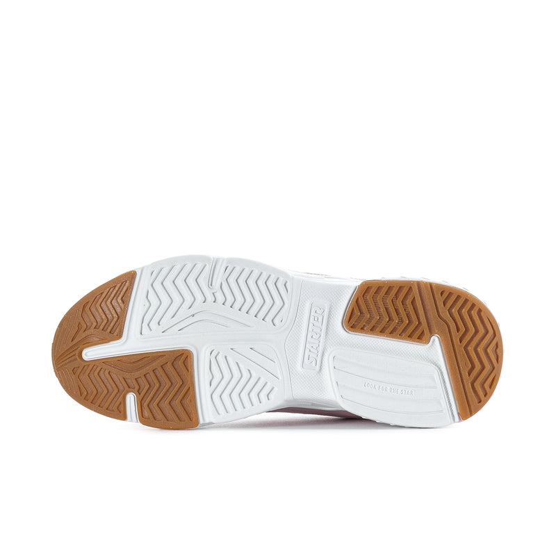 Sneaker outsole in white with brown traction pods and zigzag tread