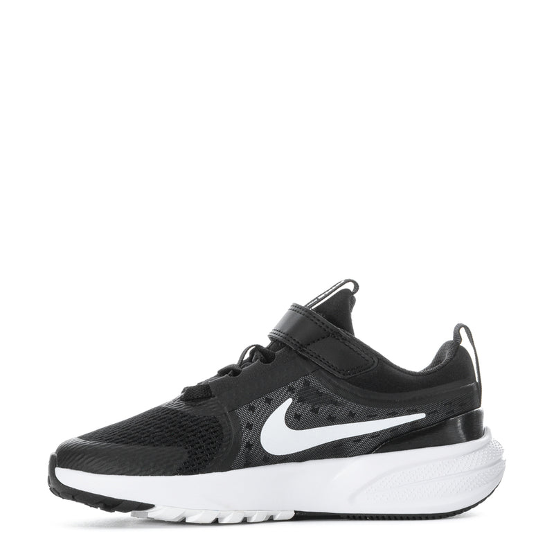 Kids black sneaker side view with white Swoosh, hook-and-loop strap, and tread sole
