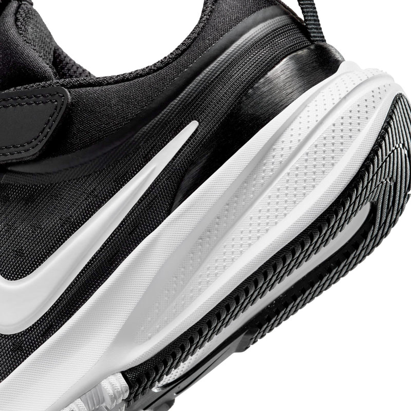 Kids black sneaker close-up of white midsole and textured side tread