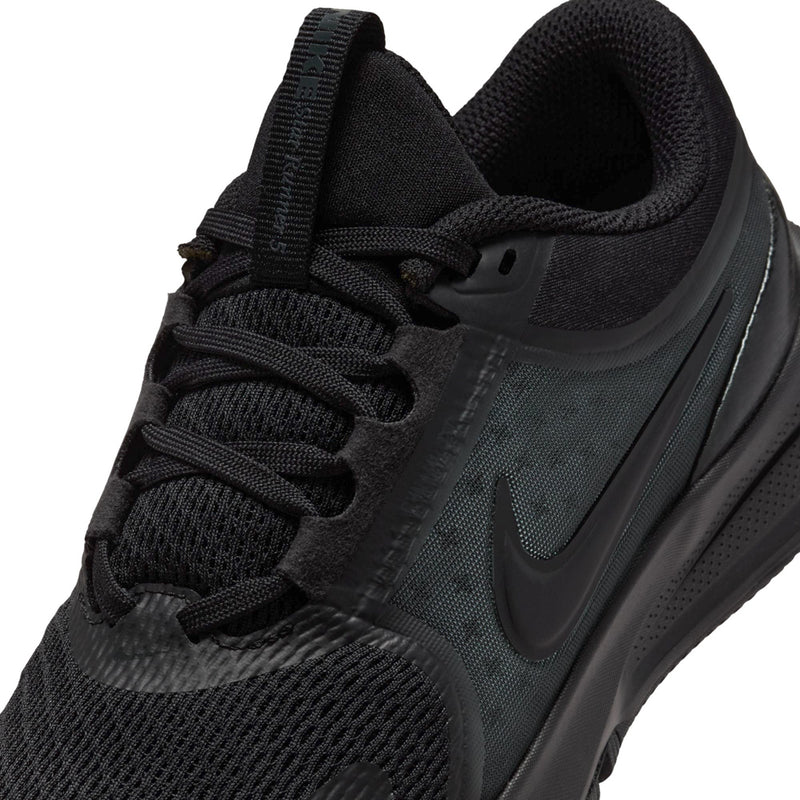 Youth lace-up running shoe close-up with textured knit upper and swoosh logo