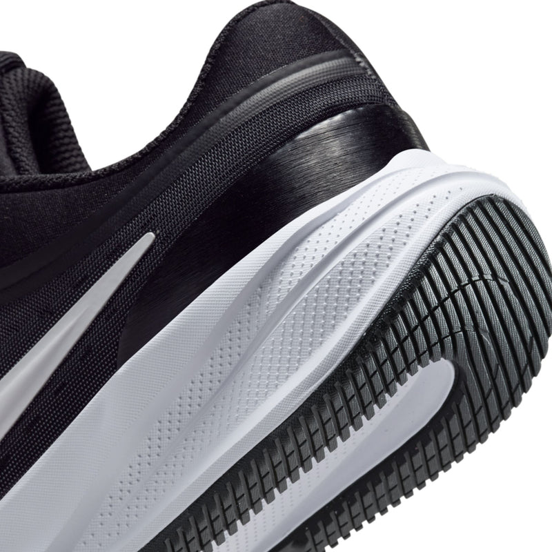 Youth sneaker side and outsole close-up with black tread and white midsole