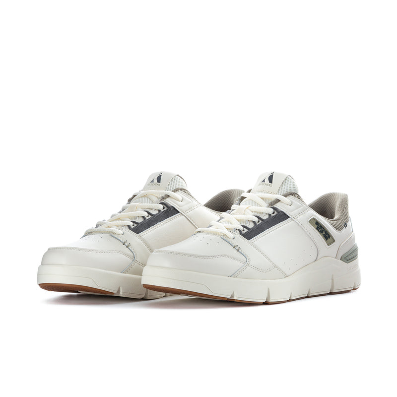 Pair of white low-top sneakers with green side stripe and lace-up styling